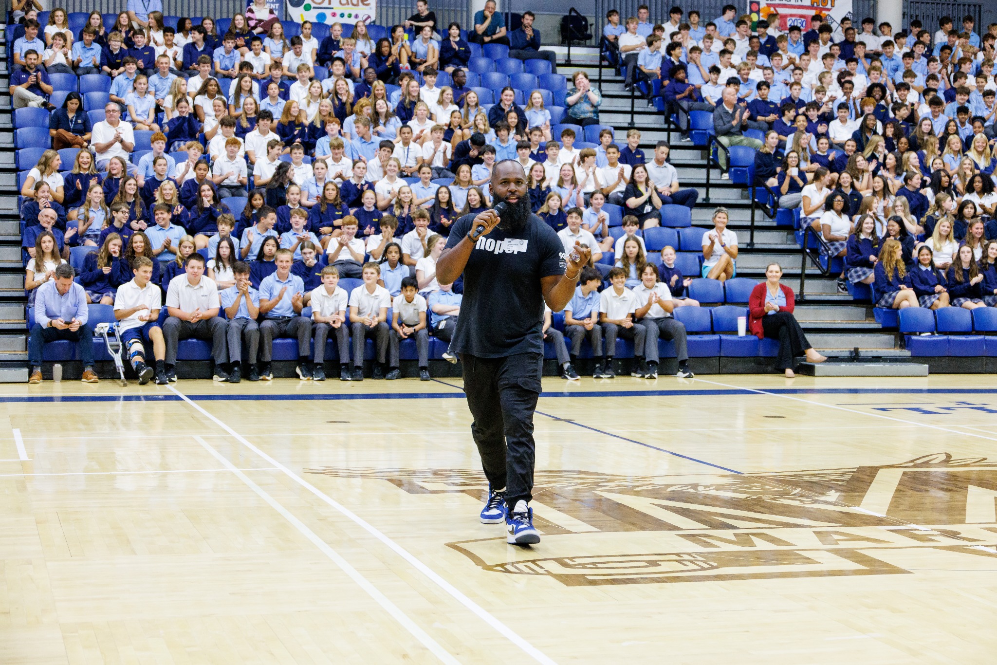 Andre Fluellen speaking to a large student audience