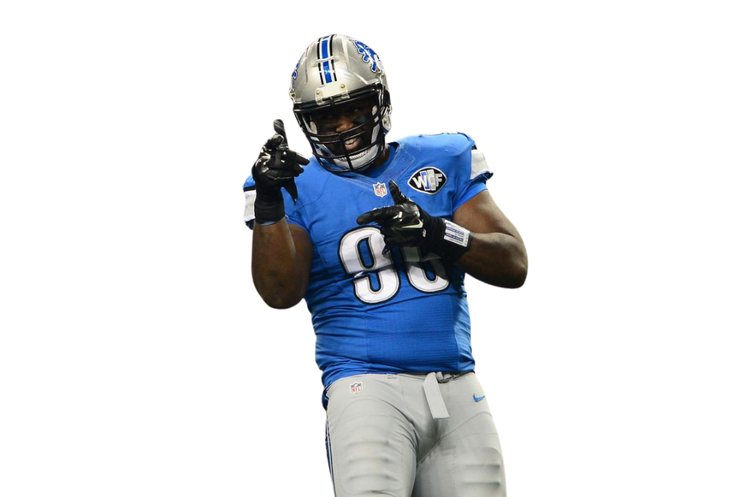Andre Fluellen in his Detroit Lions number 96 uniform, smiling and pointing toward the camera